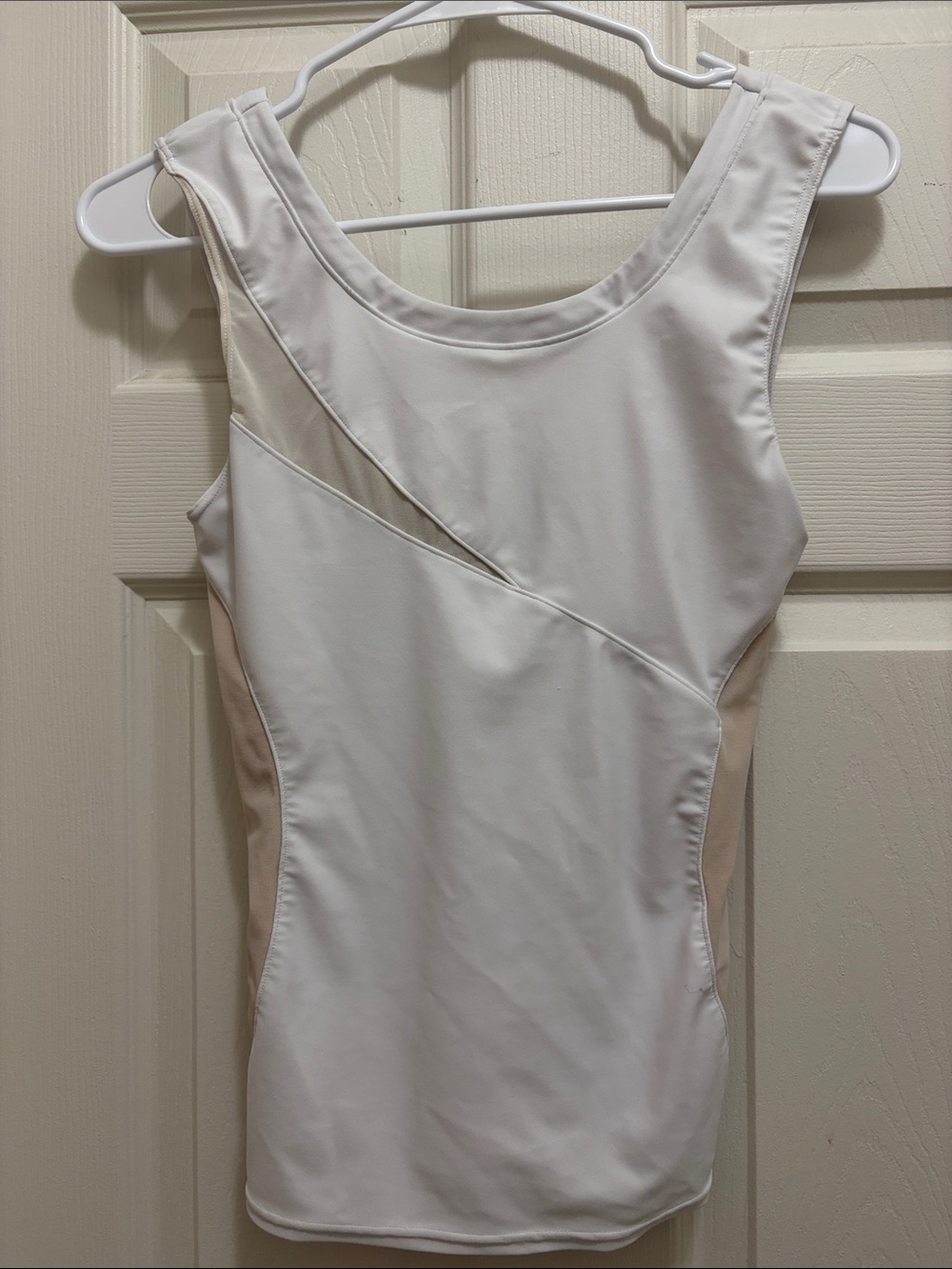 White and Beige Sleeveless Tank Top by Amari Active with sheer cutouts